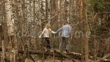 可爱的女孩和男孩走在桦树林里